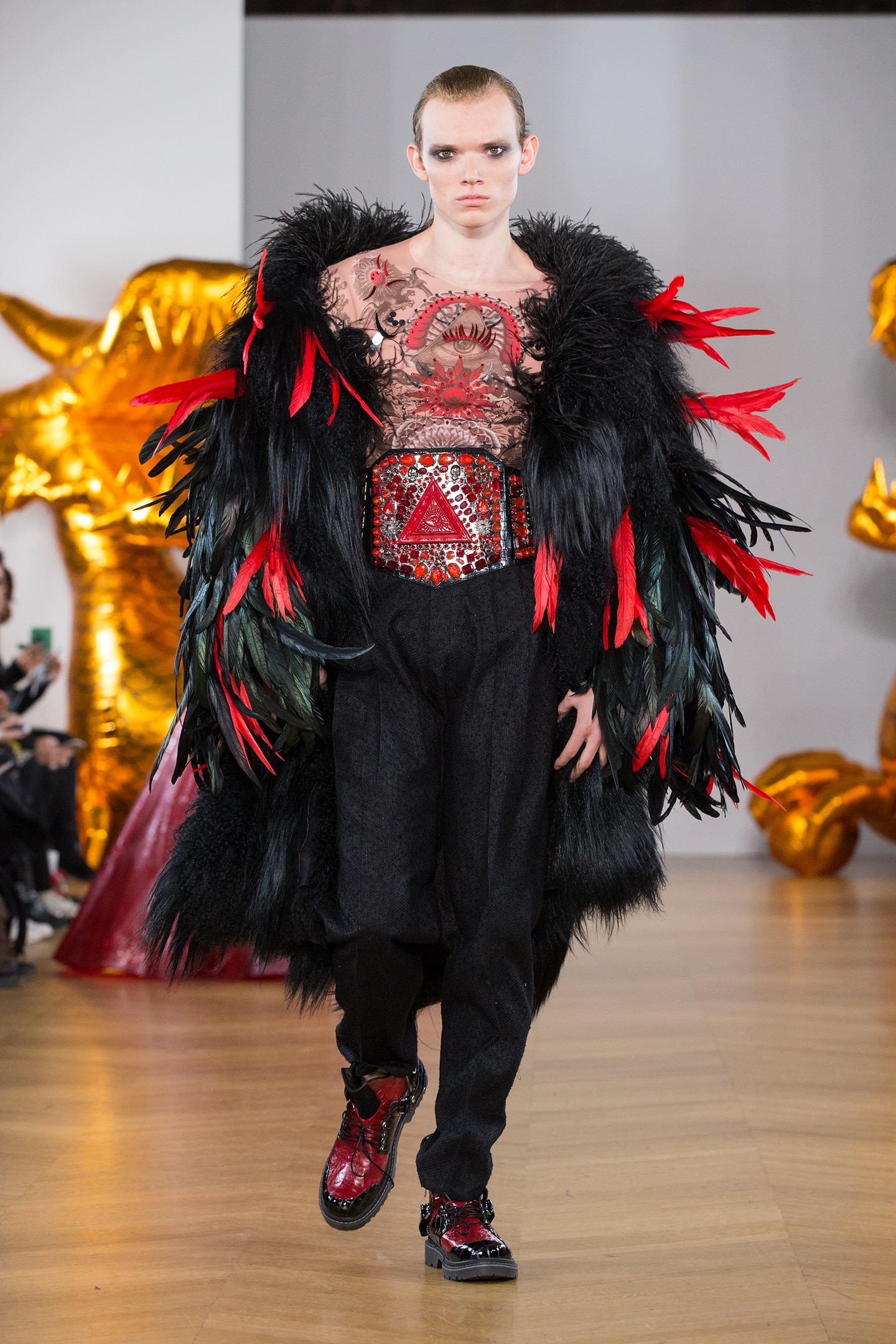 male model wearing feather and fur black red coat tatoo print top by on aura tout vu 