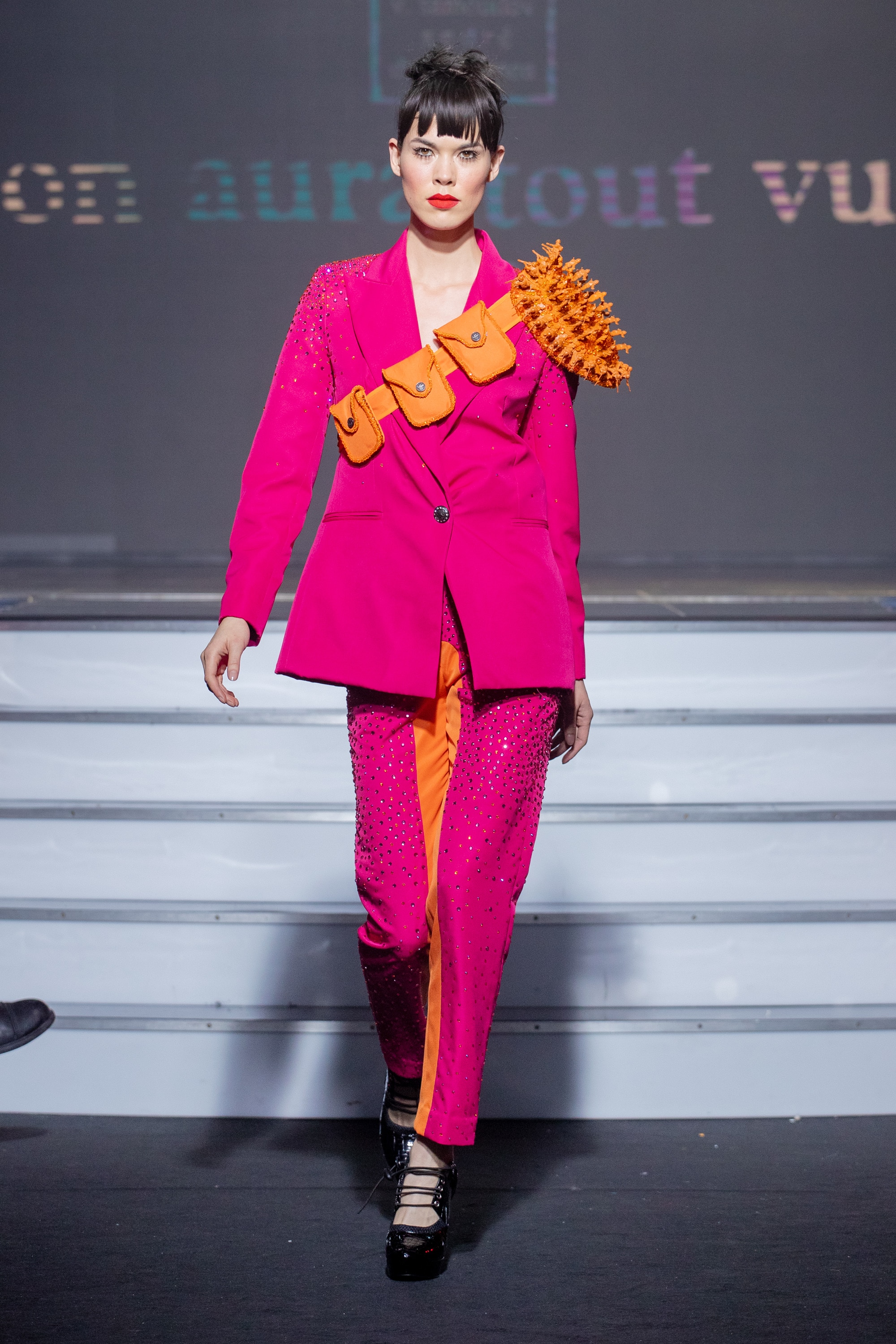 a model wearing  pink and orange  silk  outfit  crystal  and belt  by on aura tout vu haute couture spring summer 2020