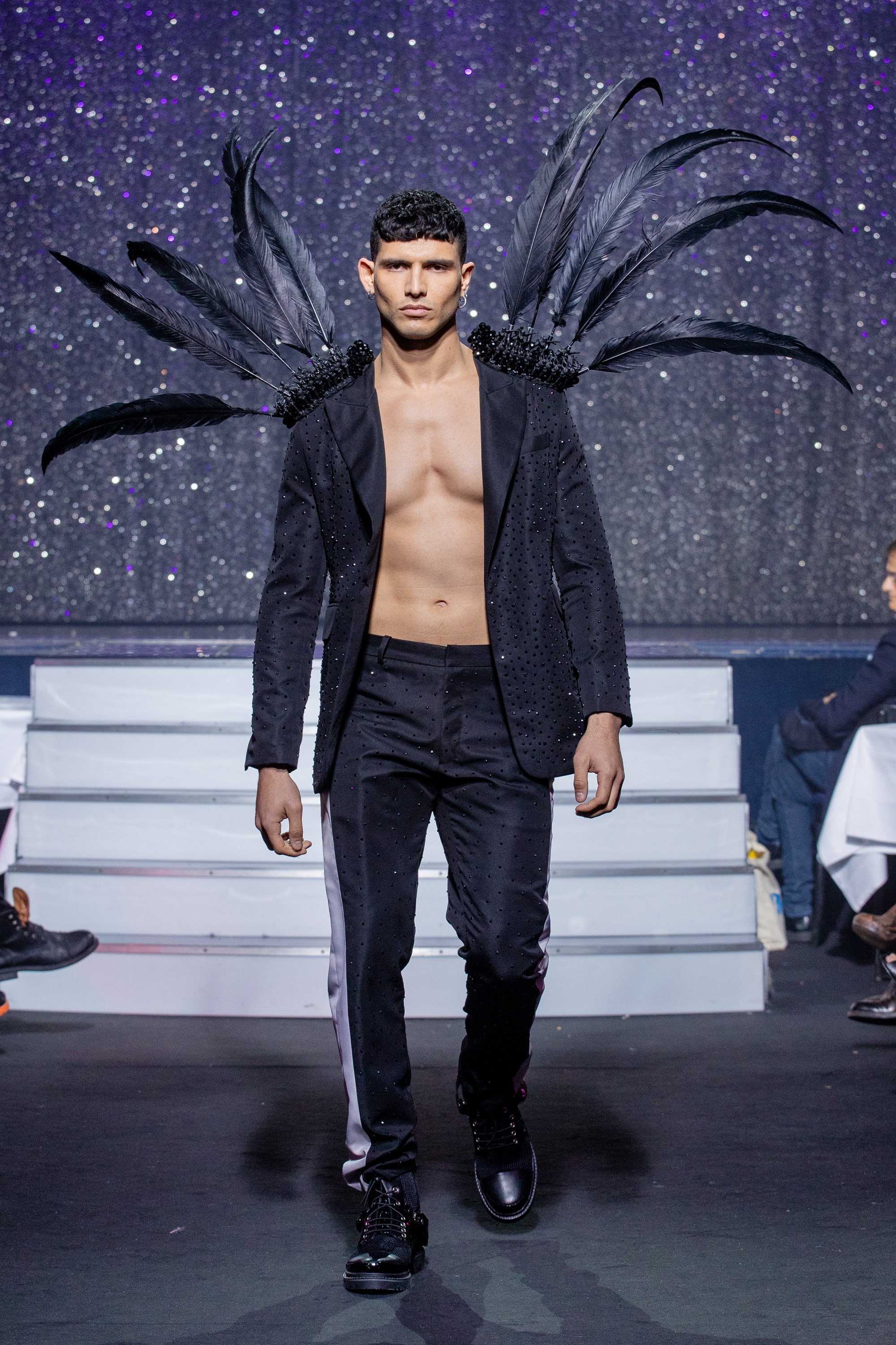a men model wearing  black  silk  outfit  crystal feathers by on aura tout vu haute couture spring summer 2020