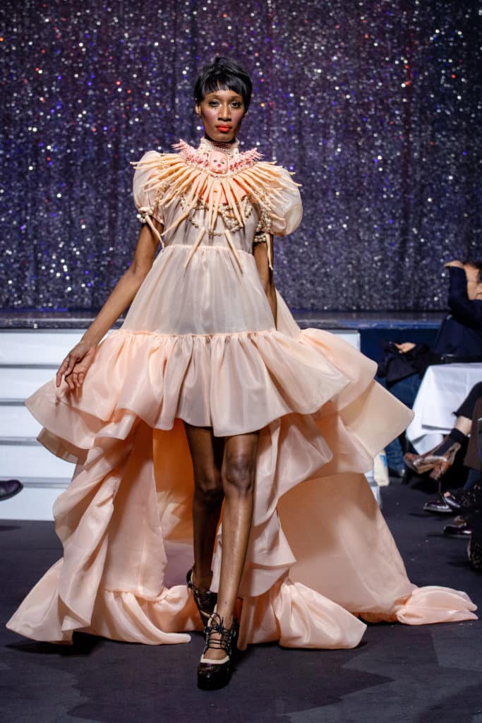 a model wearing  pink silk  outfit  crystal    by on aura tout vu haute couture spring summer 2020