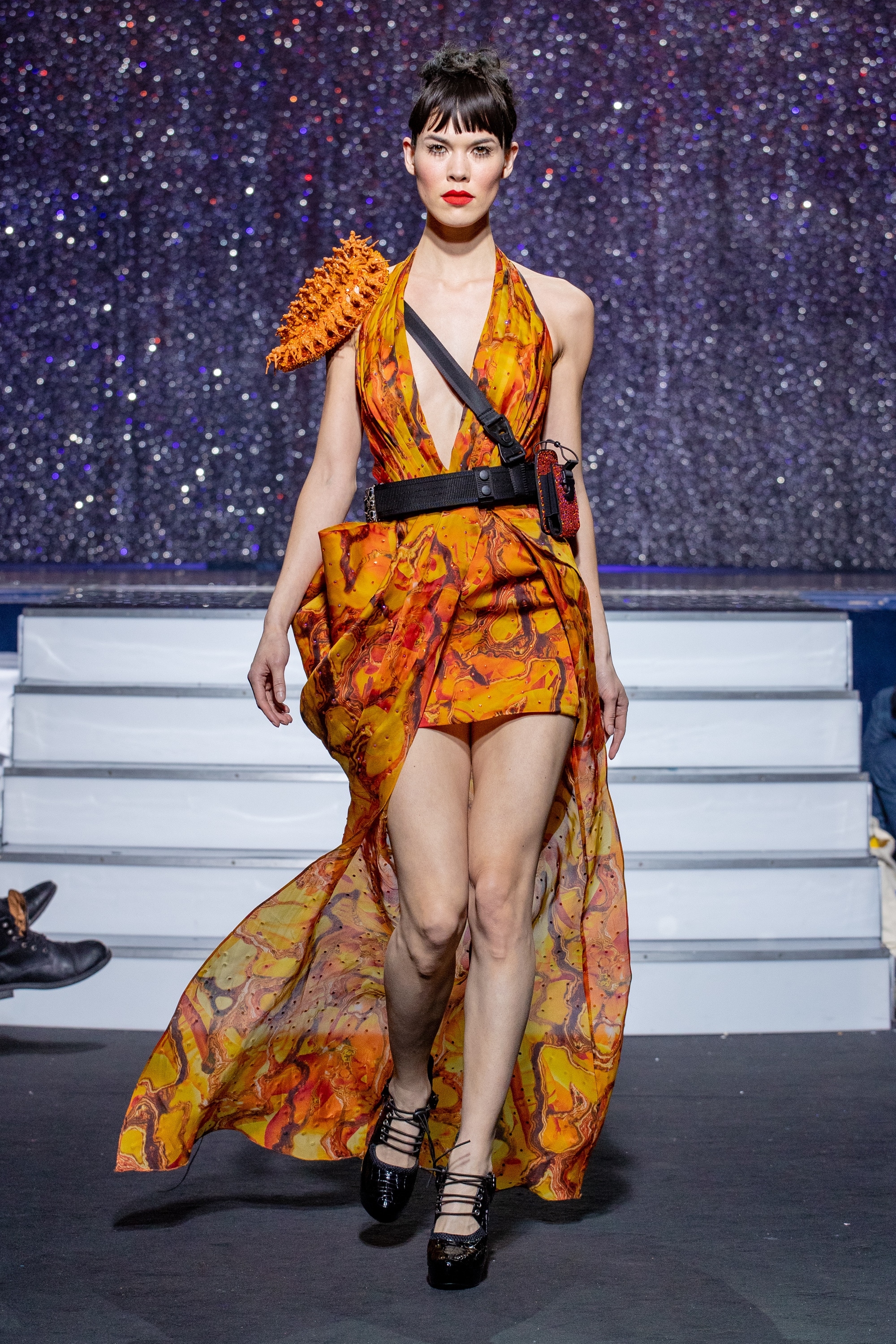 a model wearing  orange silk  outfit  crystal  and belt  by on aura tout vu haute couture spring summer 2020