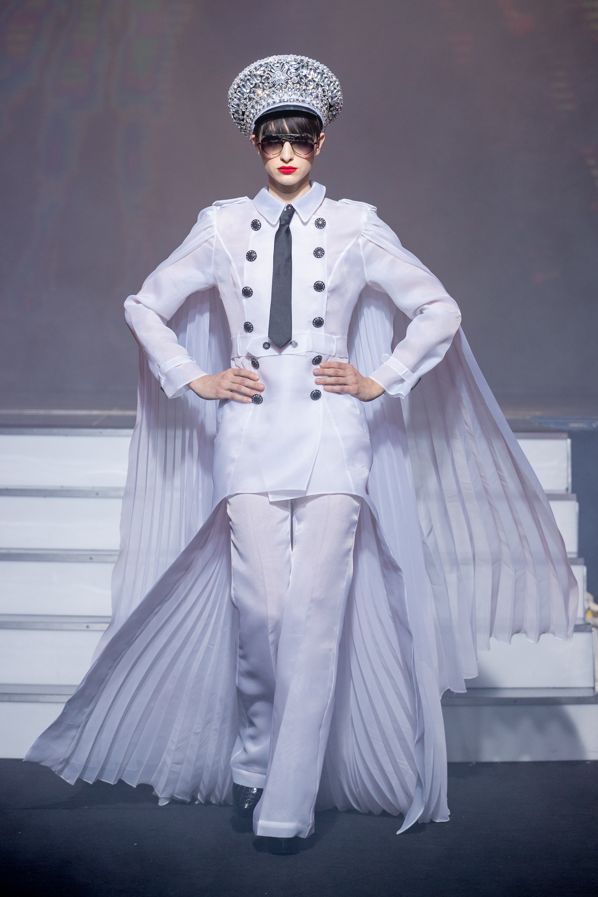 a model wearing Military white outfit pockets and crystal hat eyewear by on aura tout vu couture spring summer 2020