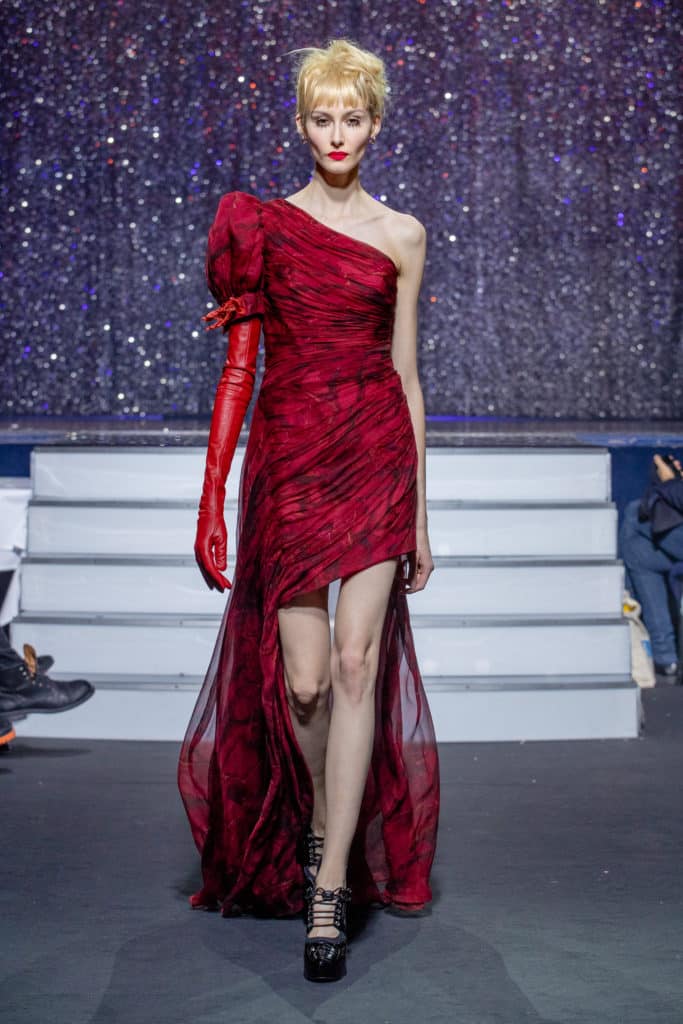 a model wearing  red silk  dress crystal   by on aura tout vu haute couture spring summer 2020