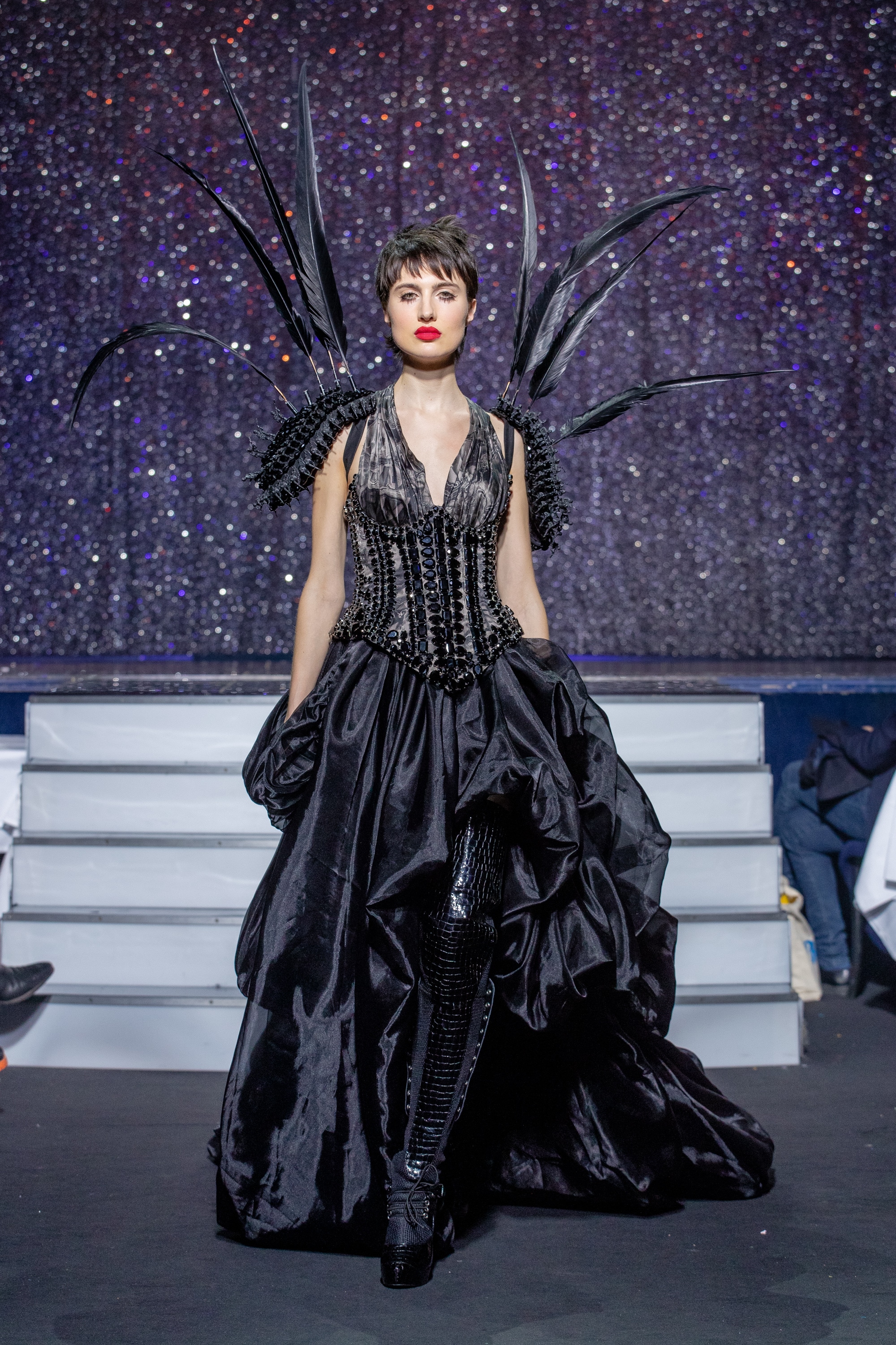 a model wearing  black silk  outfit  crystal  and belt  by on aura tout vu haute couture spring summer 2020