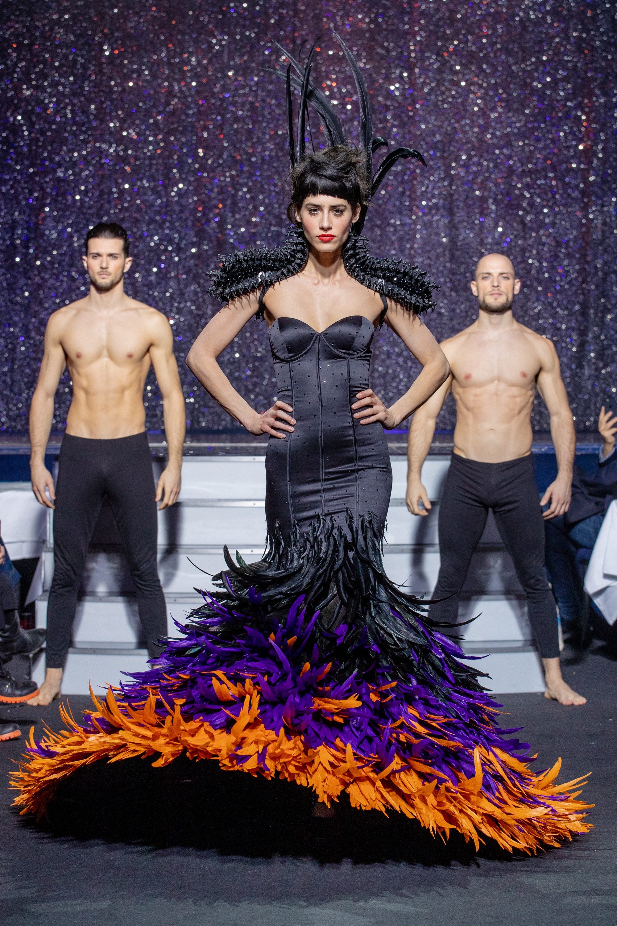 a model wearing  black purpple orange feathers silk dress  crystal   by on aura tout vu haute couture spring summer 2020