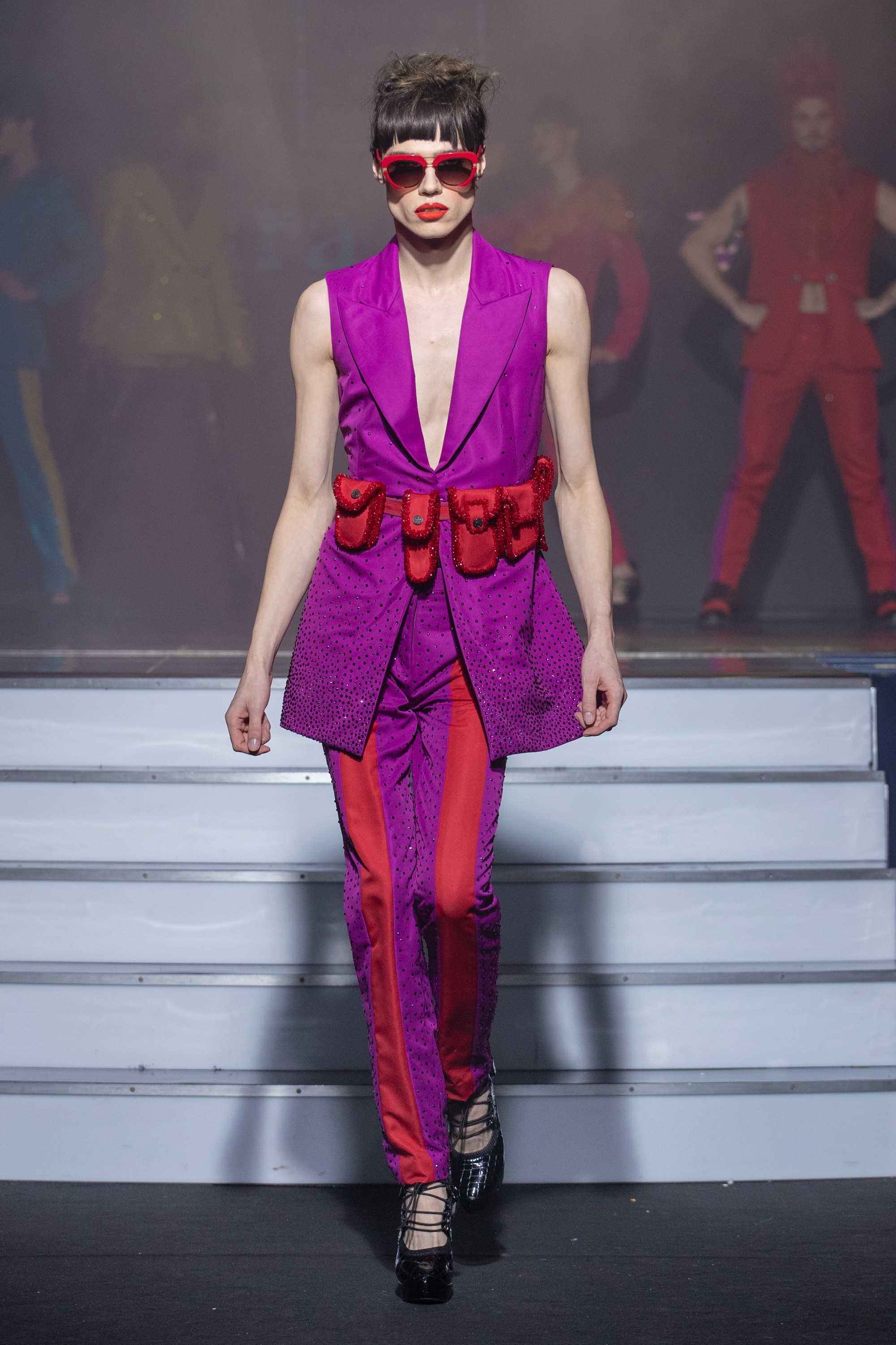 a model wearing  violet and red silk  outfit  crystal  and belt  by on aura tout vu haute couture spring summer 2020