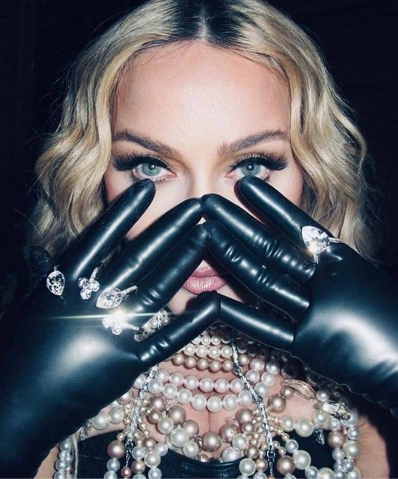 Madonna is wearing hand cuff rings and pearls necklace by on aura tout vu 